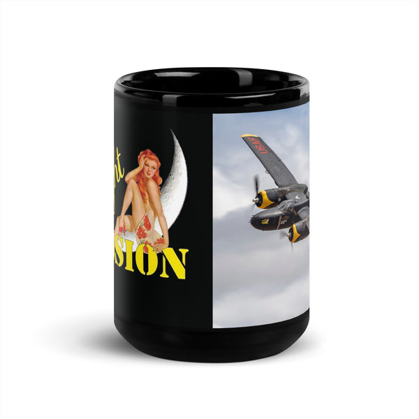 A black ceramic coffee mug with a split design featuring a pin-up style illustration on one side and an aerial photograph of an A-26 Invader aircraft on the other.