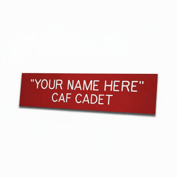 A red name tag with white text that reads 'YOUR NAME HERE CAF CADET', designed for CAF Cadet members to personalize with their own name.