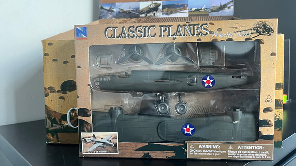 Model airplane in packaging with 'Classic Planes' branding on a reflective surface.