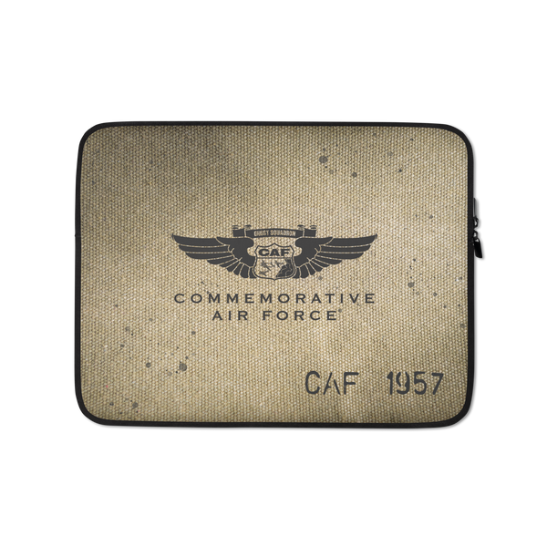 A brown laptop sleeve with a vintage military badge design, featuring the text 'COMMEMORATIVE AIR FORCE CAF 1957'.