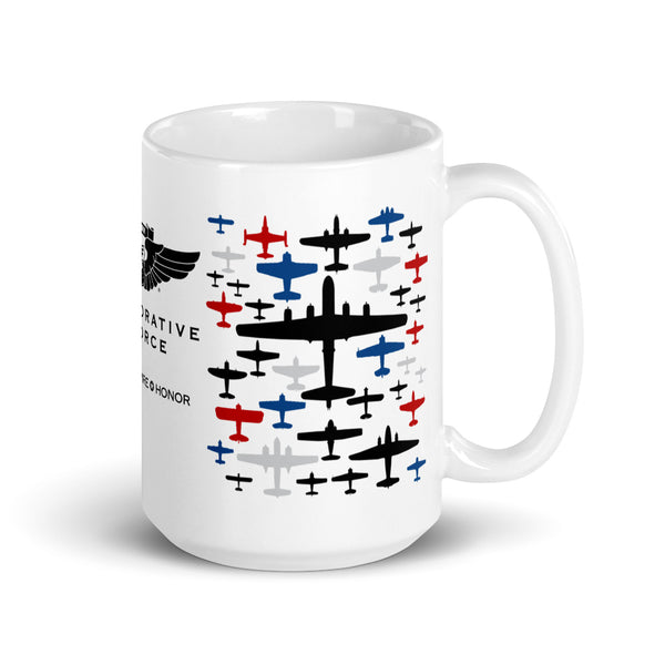 A white ceramic mug with a colorful print featuring aircraft and the text 'CAF Commemorative Air Force EDUCATE INSPIRE HONOR'.